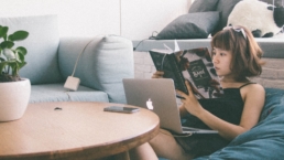 Woman relaxing while reading a book and lounging